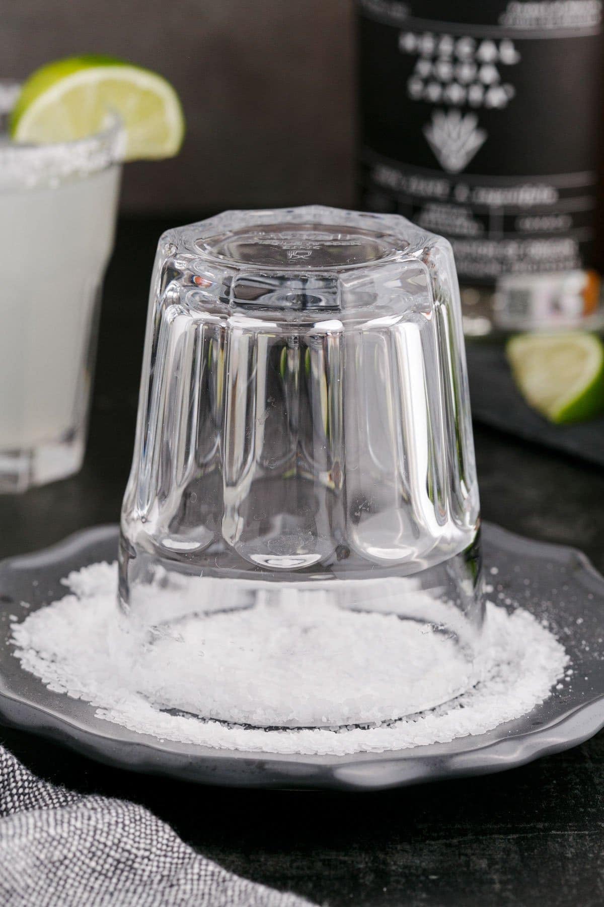 a glass turned upside down in a plate of coarse salt