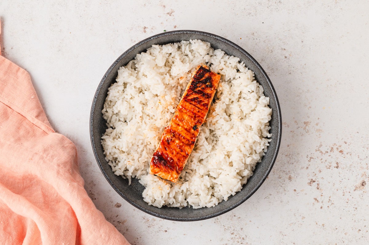 rice and grilled salmon in. agray bowl.