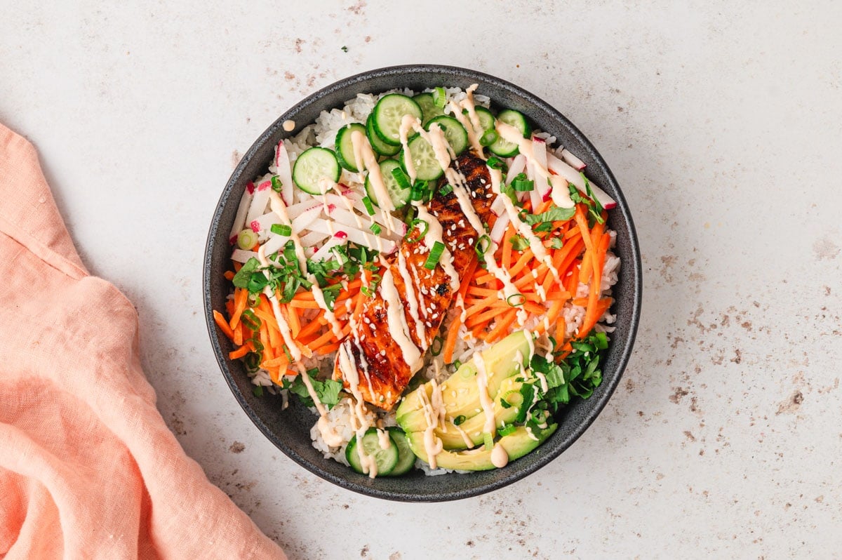 Salmon Rice bowl with drizzle of sauce.
