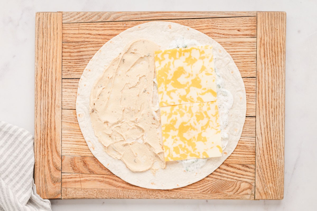 Flat tortilla with hummus and cheese.