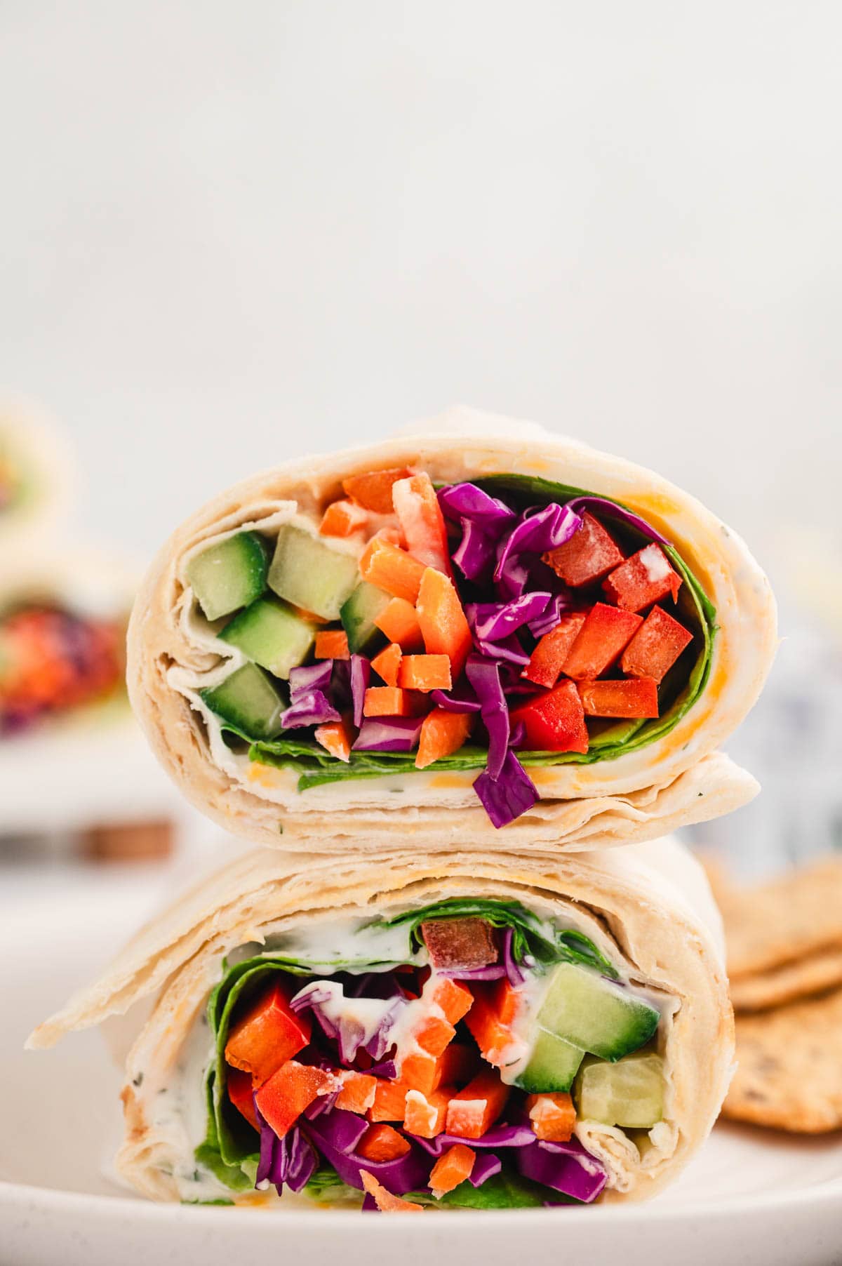 Two veggie wraps stacked on top of each other.