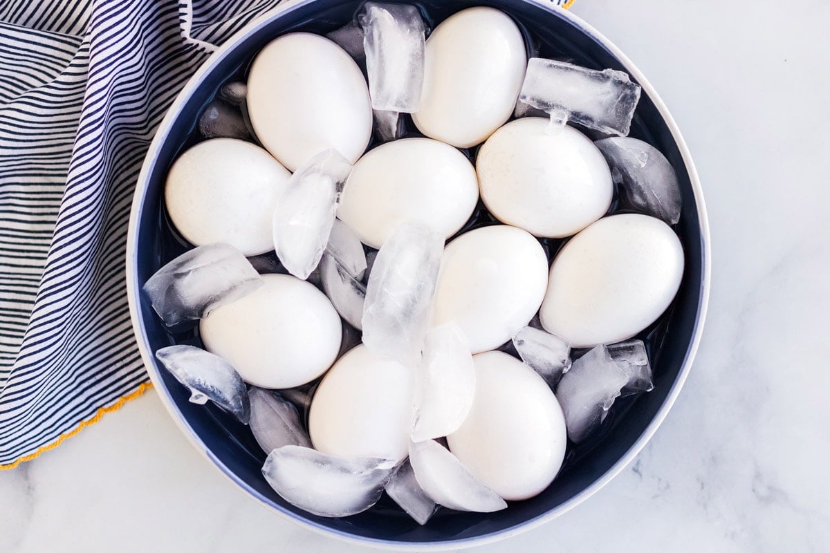 Eggs in ice and water in a large bowl.