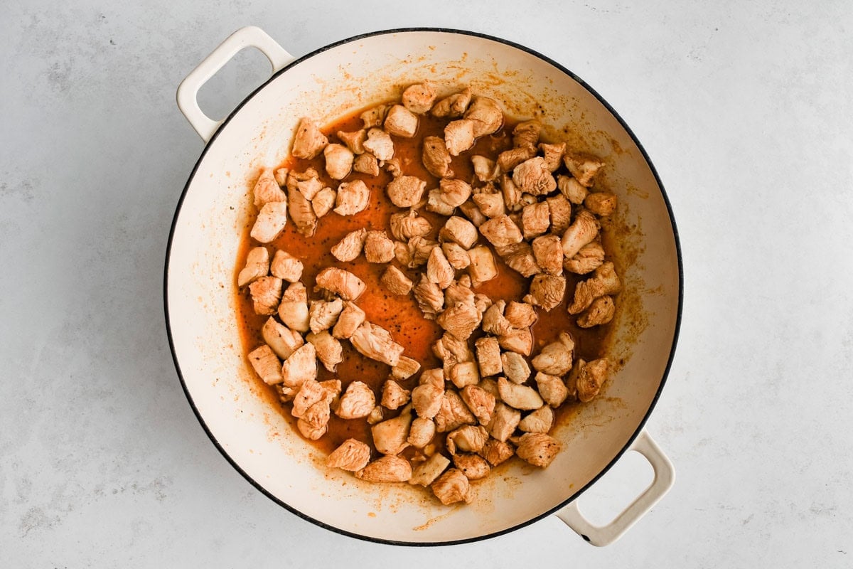diced chicken in a skillet.