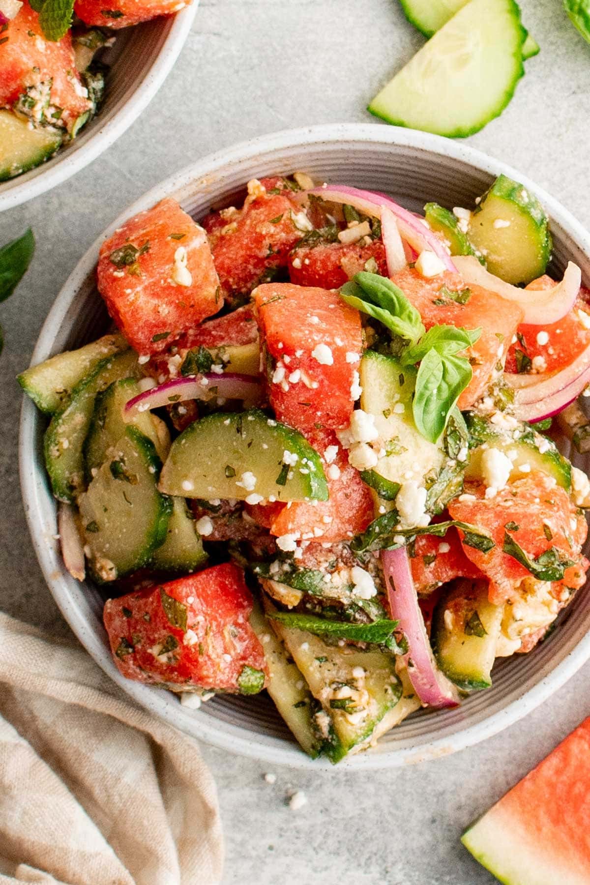 Serving bowl with watermelon, cucumbers and feta.