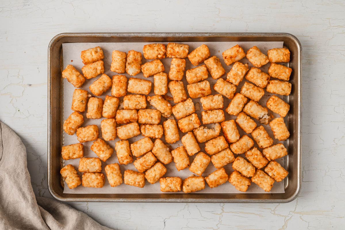 tater tots arranged on a baking sheet.