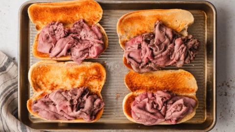 Roast beef on open hoagie rolls.