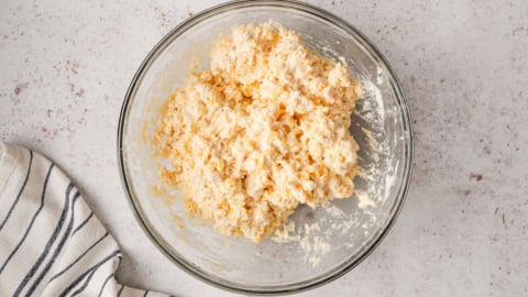 Cornbread casserole batter in a glass bowl.