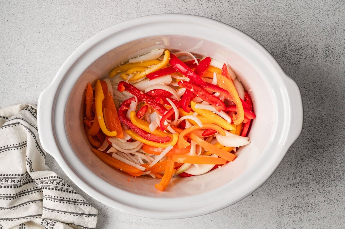 sliced peppers in a crockpot.