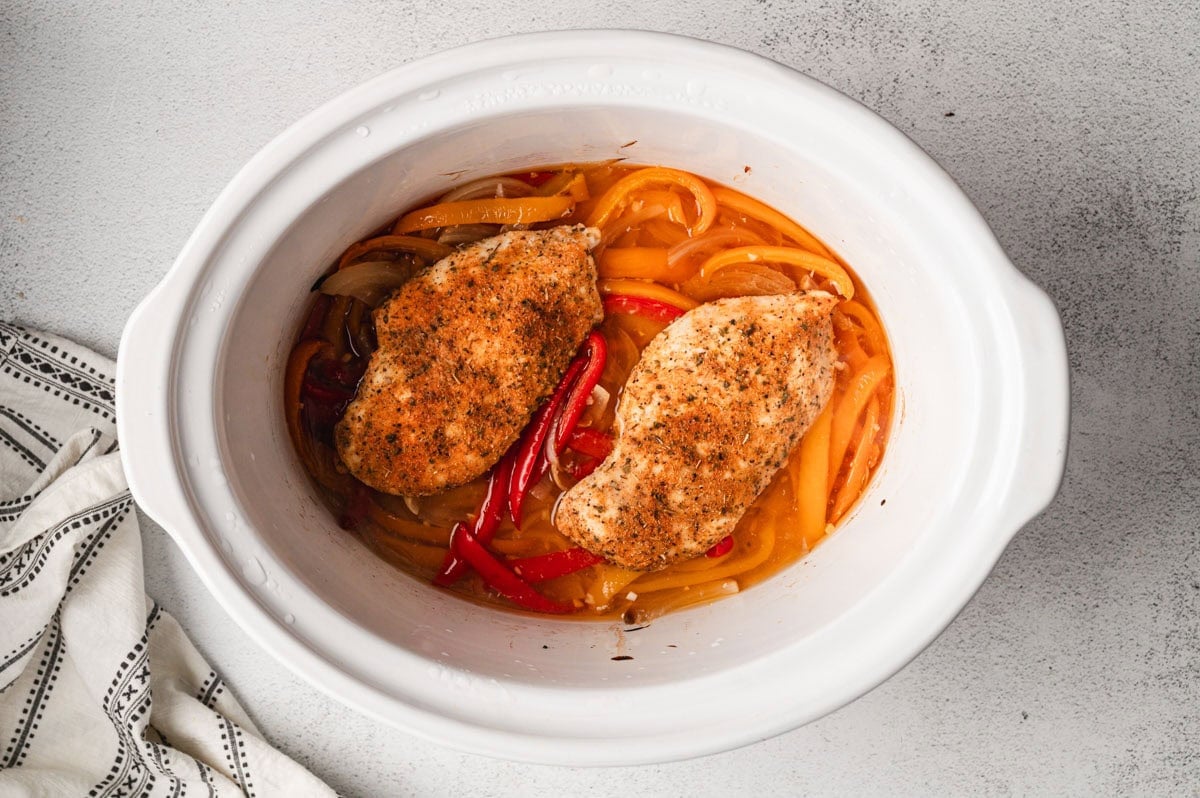 cooked chicken and peppers in a crockpot