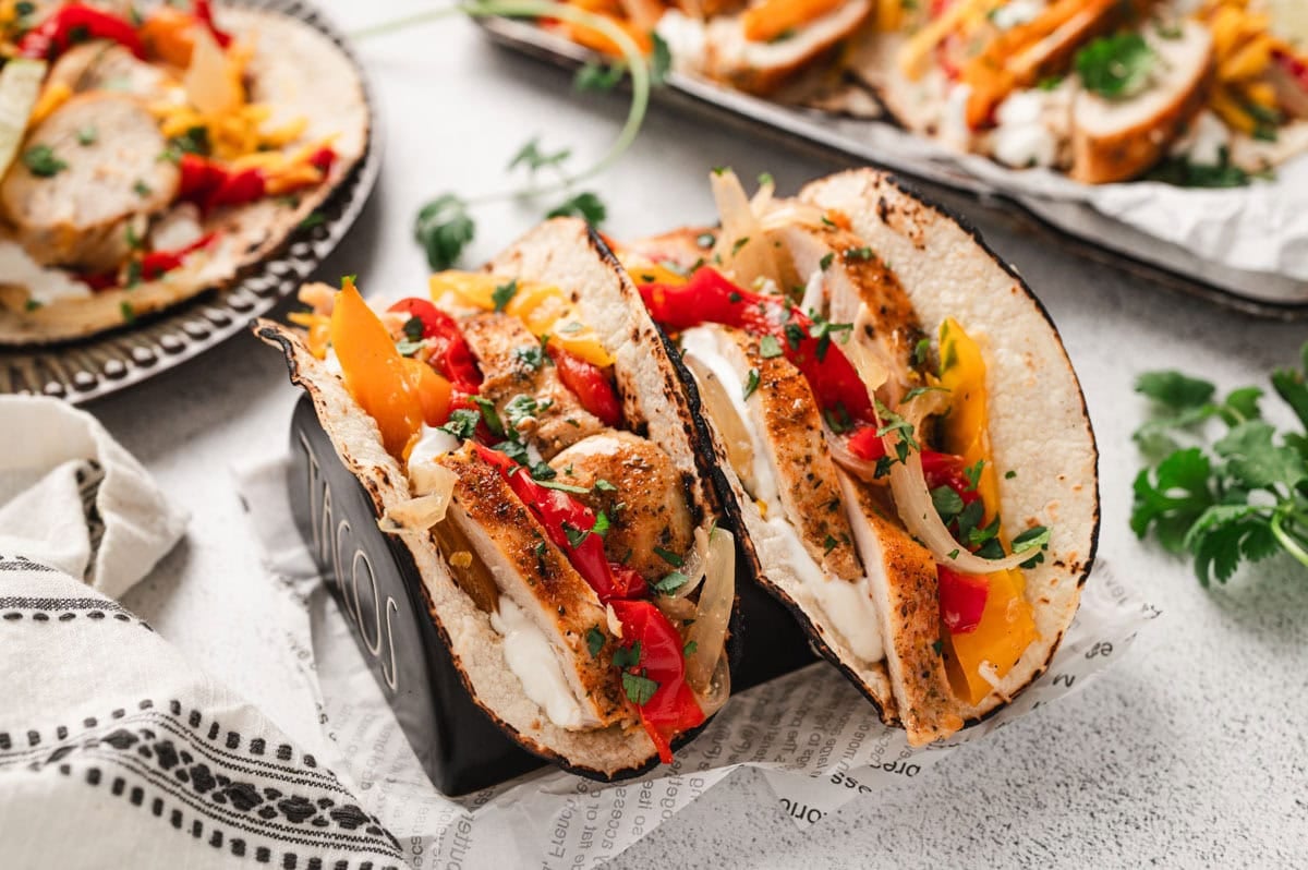 Chicken fajitas with chicken and peppers in a flour tortillas.