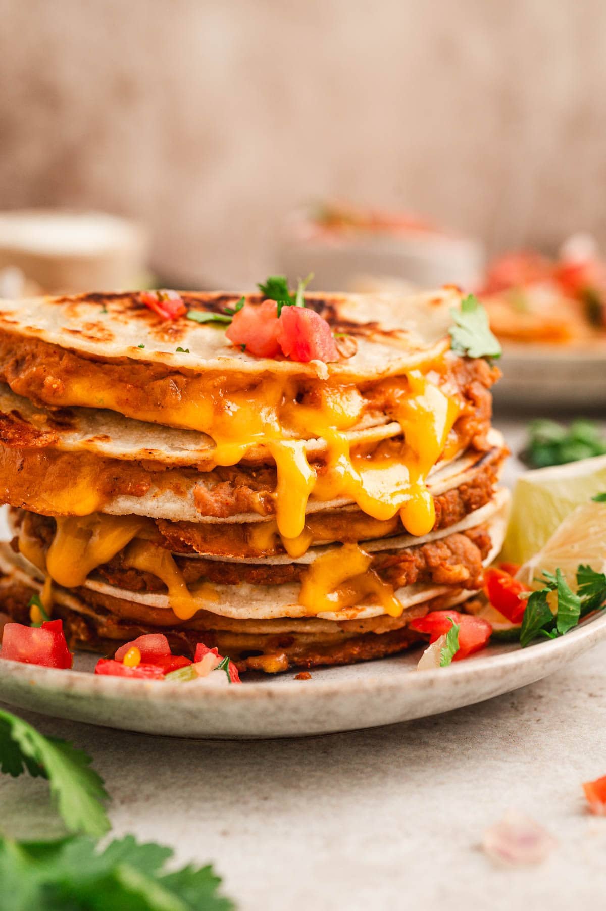 Mini bean and cheese quesadillas stacked on a plate