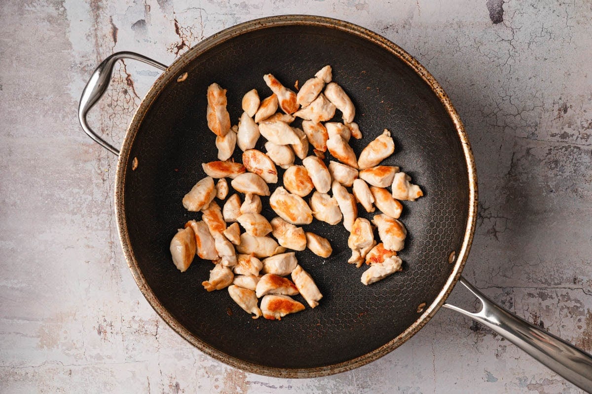 Chicken being sauteed in pan