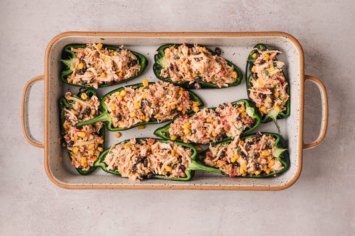 Stuffed poblano peppers in a baking dish.
