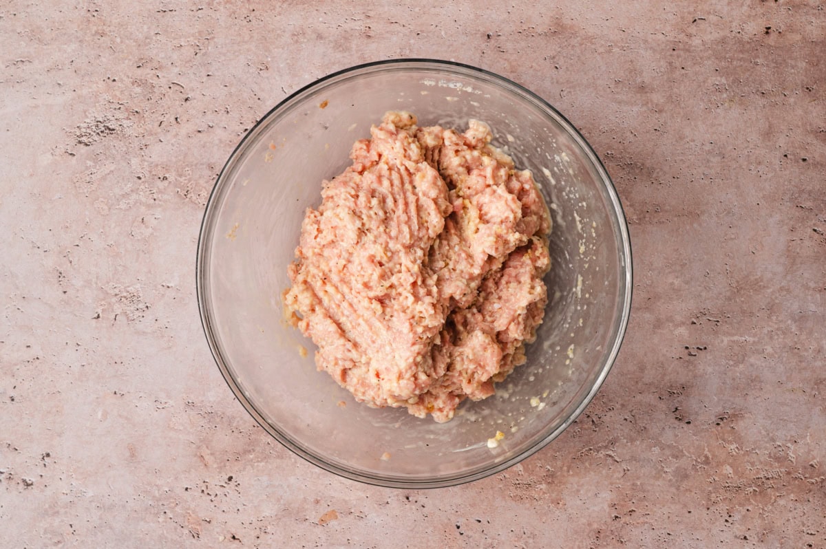 Ground chicken mixture in a glass bowl.