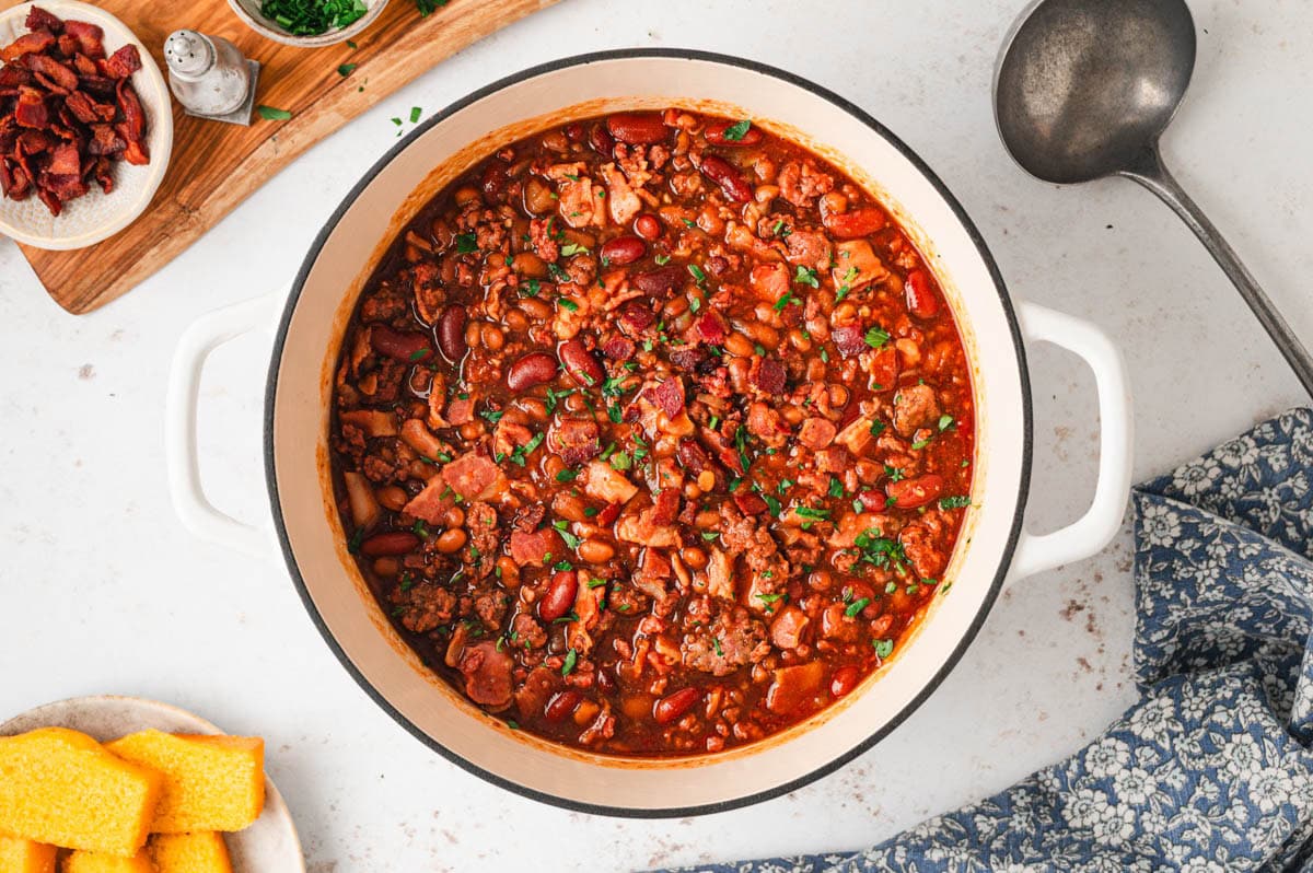 Fully cooked meaty baked beans in a dutch oven.
