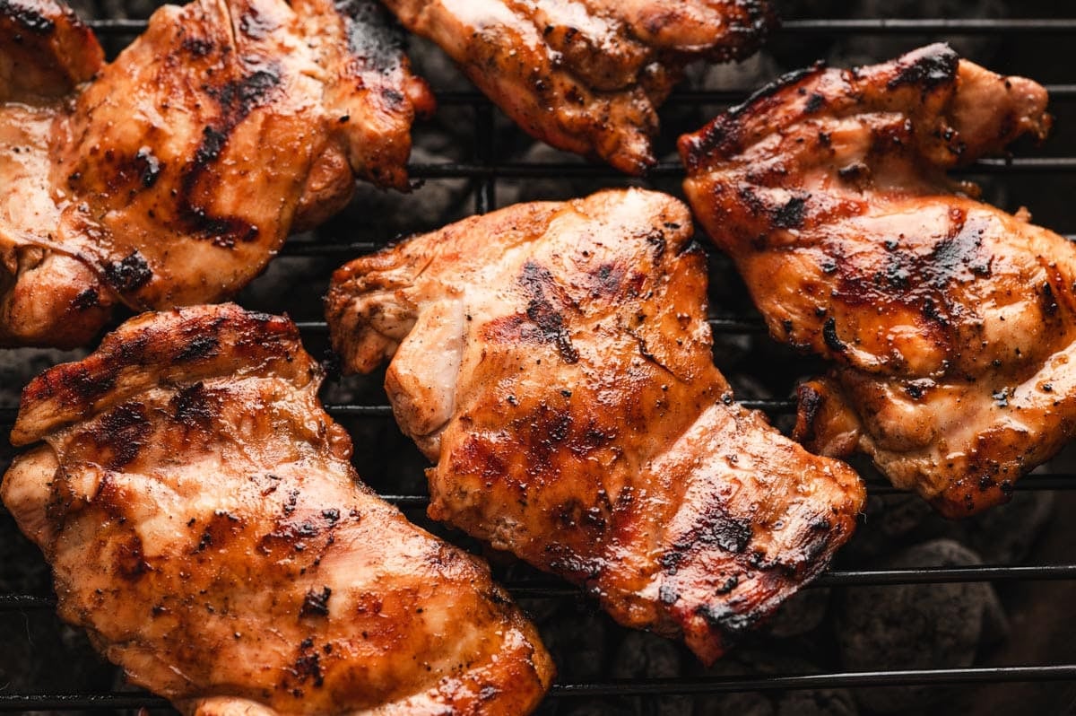 Grilled chicken thighs on a bbq grill.