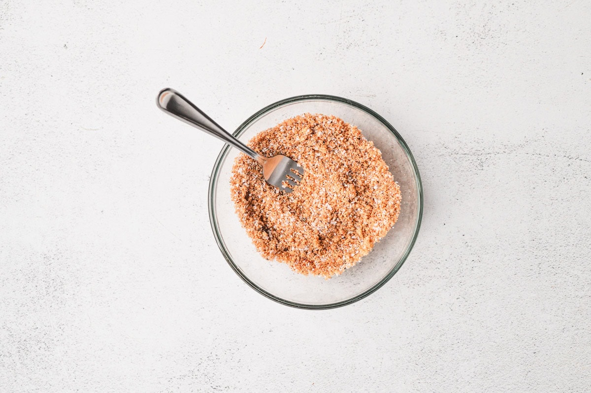 Homemade BBQ rub in a glass bowl after being mixed together.