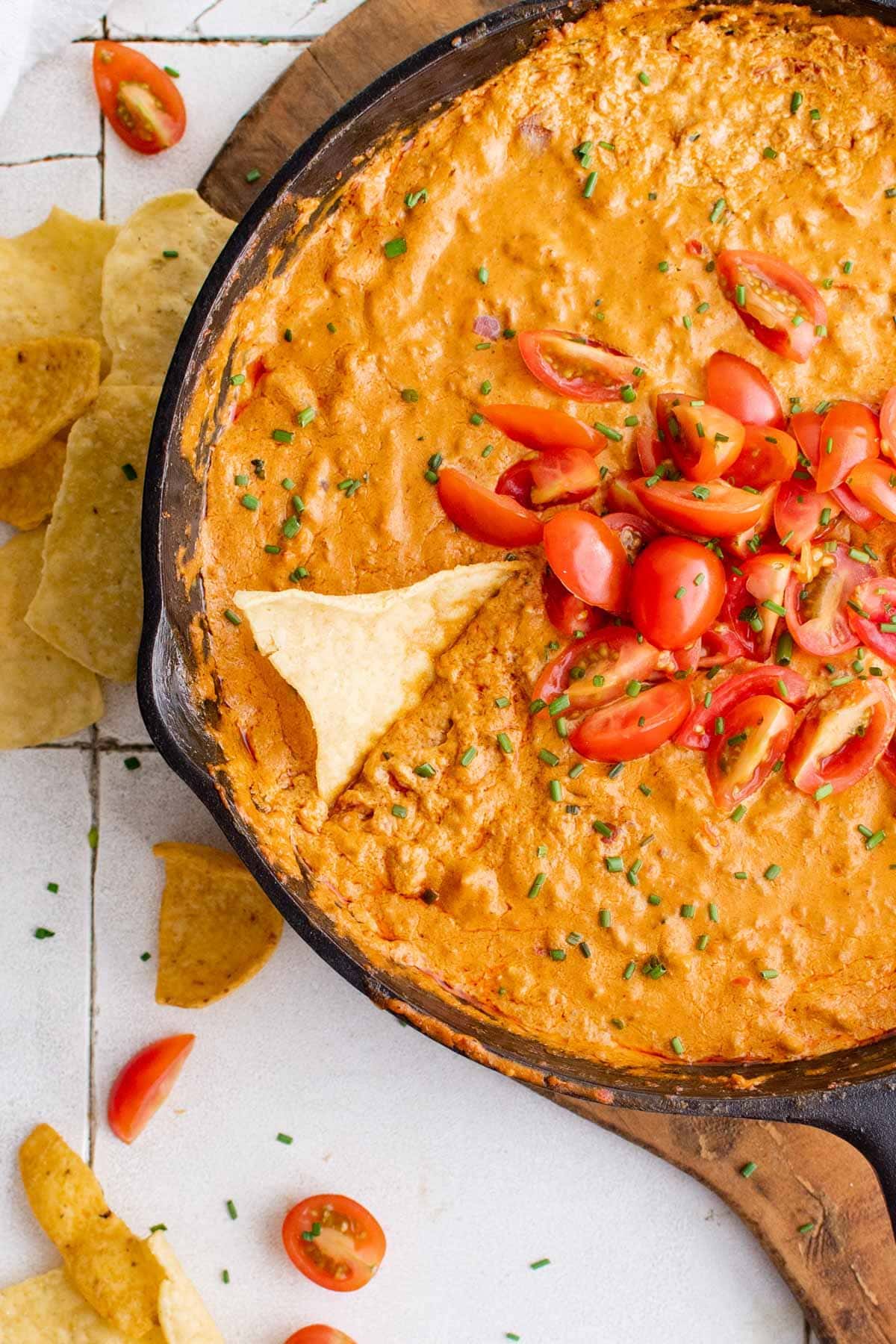 sausage dip in skillet with tomatoes and tortilla chips