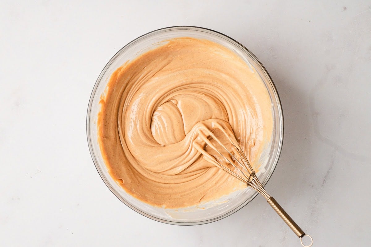 Peanut butter, vanilla, and salt whisked into the melted white chocolate.