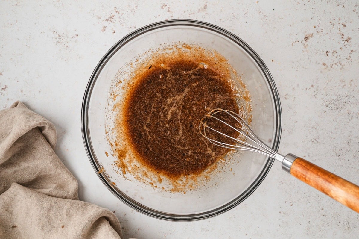 Melted butter, brown sugar, egg and vanilla whisked in a glass bowl.
