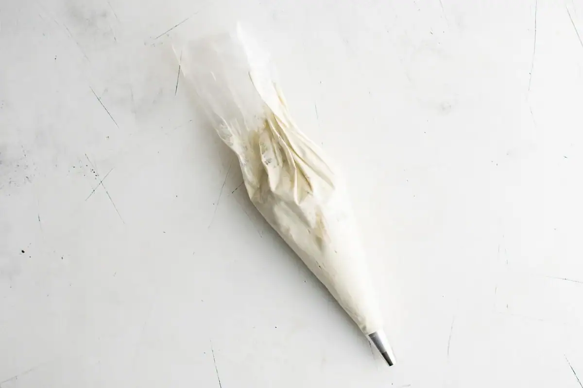 Piping bag filled with blue cheese mixture.