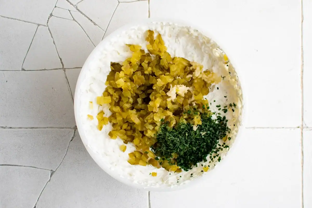 Ingredients for dill pickle dip in a bowl.
