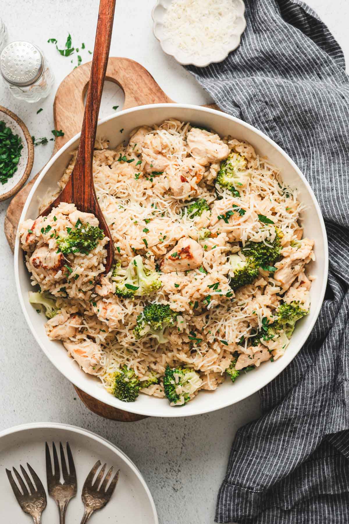 Instant Pot Chicken and Rice in a large white bowl with a wooden spoon.