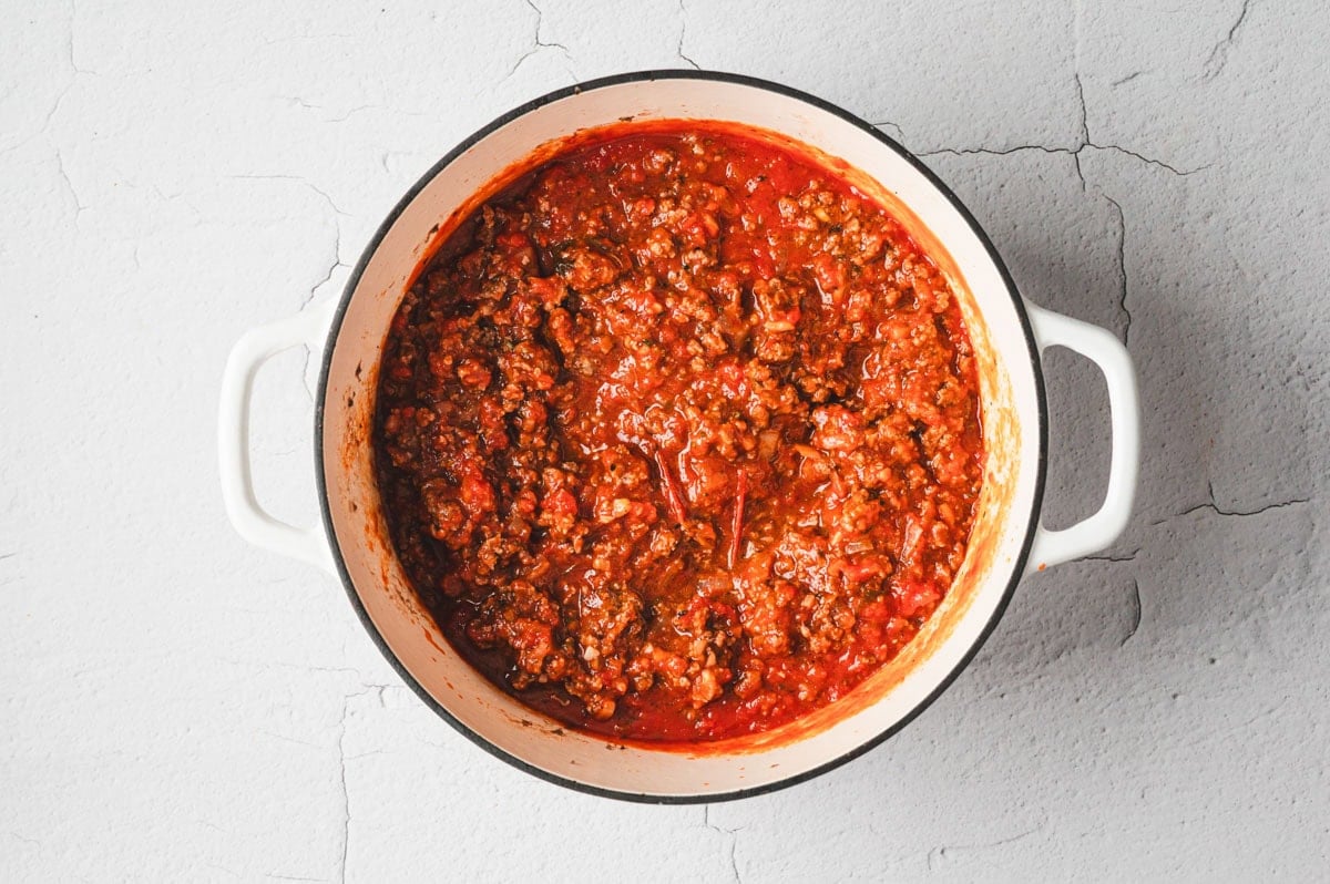 Bolognese sauce in a white pot.