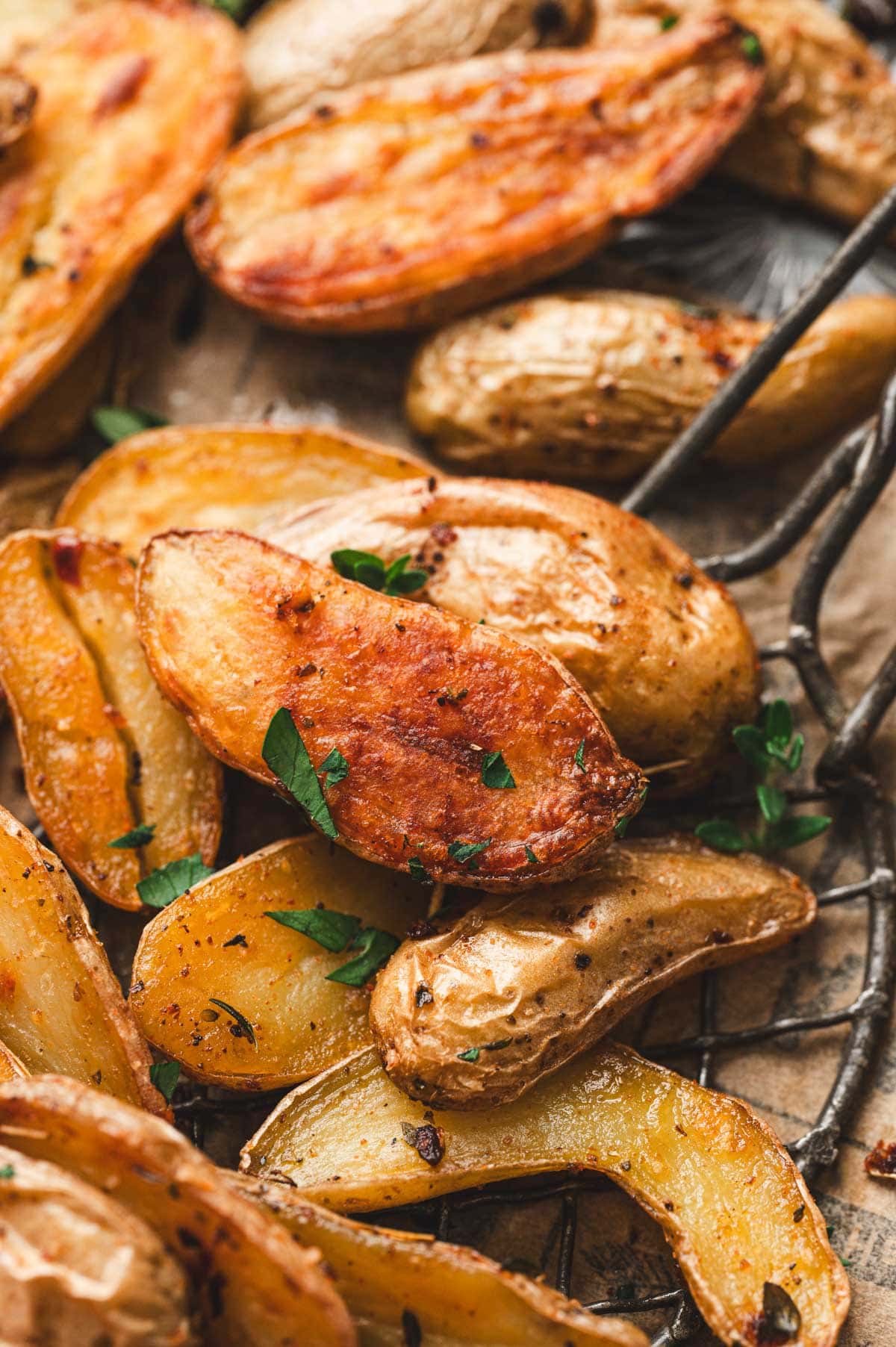 Close up of roasted fingerling potatoes garnished with parsley.