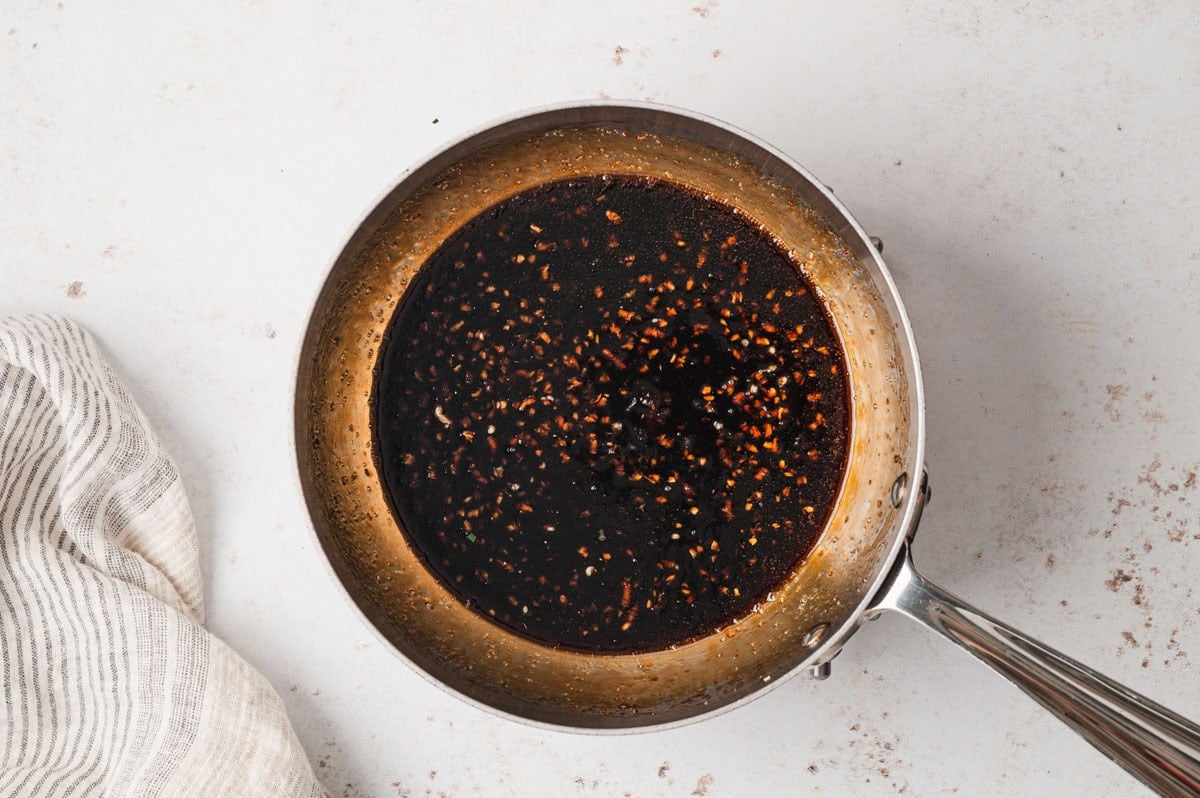 Brown sauce in a stainless steel saucepan.