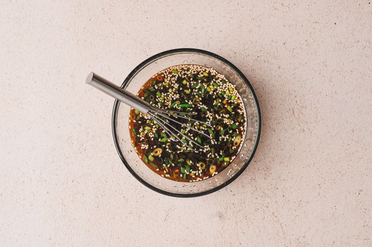 Stir fry sauce after being whisked together in a medium glass bowl.