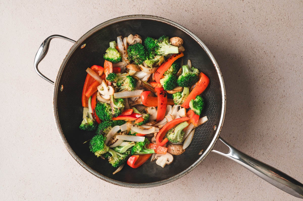 Mixed vegetables for skir fry in a Hexclad pan after being stir-fried.