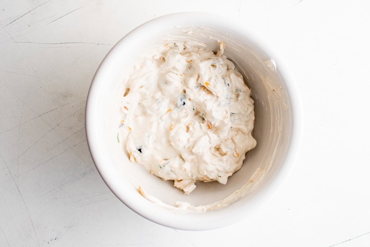 Creamy olive dip in a white bowl