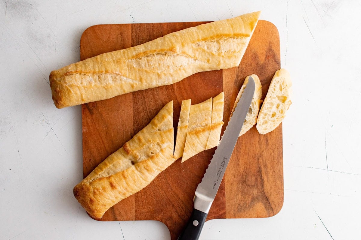 Sliced bagette on cutting board.