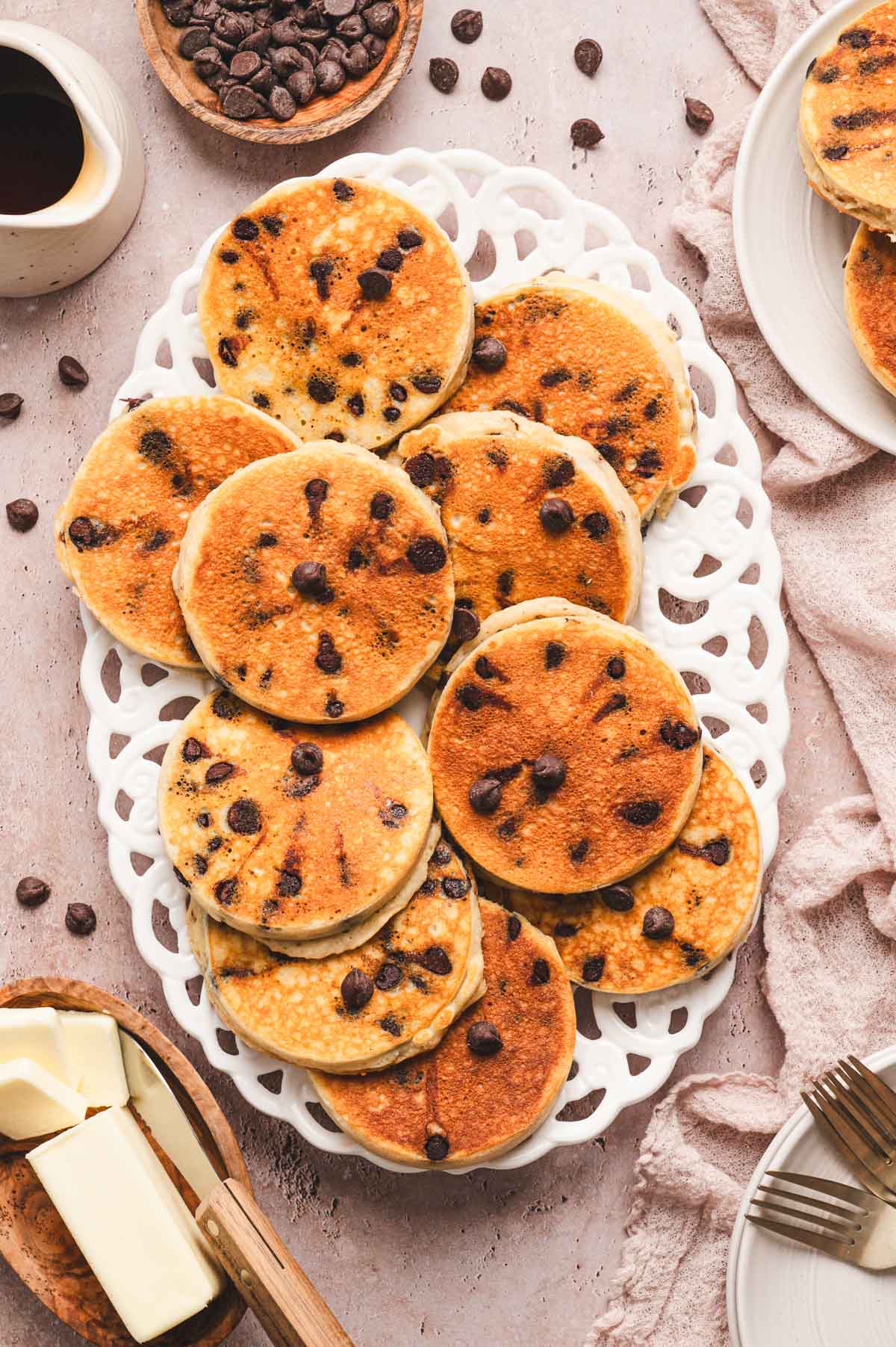 Decorative white platter with chocolate chip pancakes.