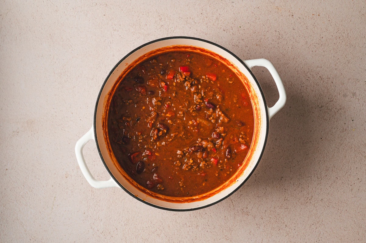 White dutch oven filled with pumpkin chili