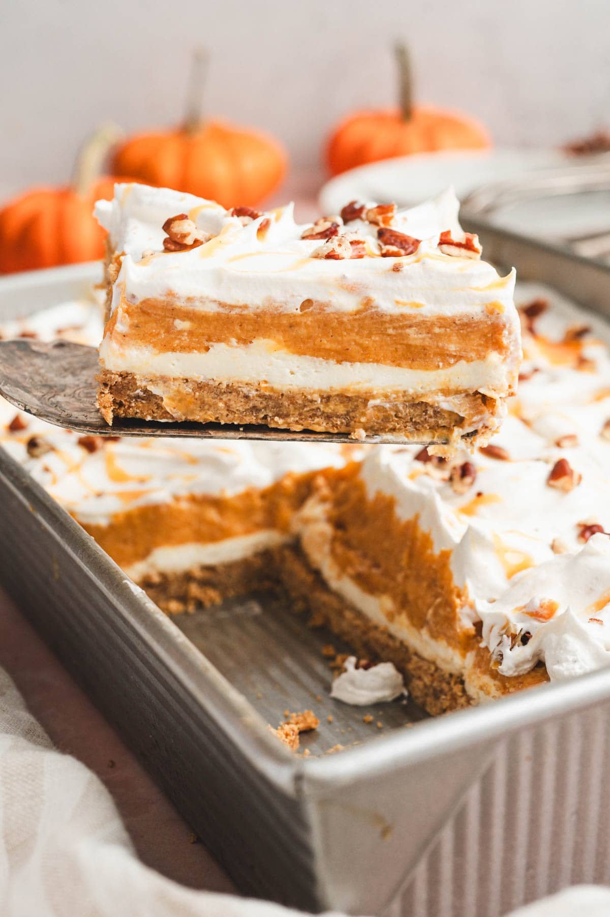 Pumpkin lasagna dessert slice on a serving utensil.