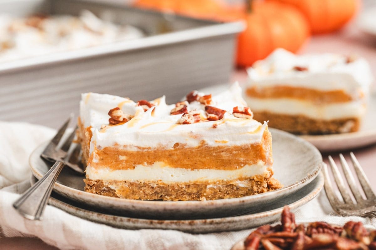 Close up of a slice of pumpkin lasagna dessert sitting on a plate.