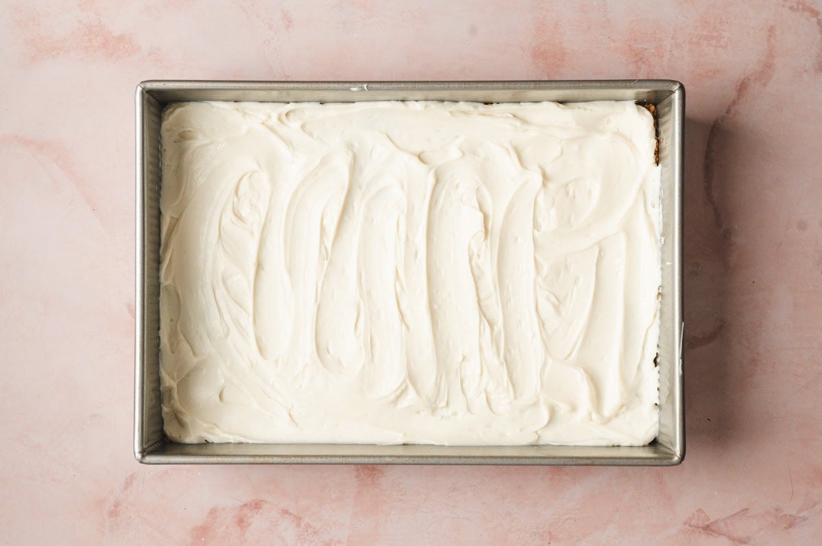 Cheesecake layered on top of a graham cracker crust.