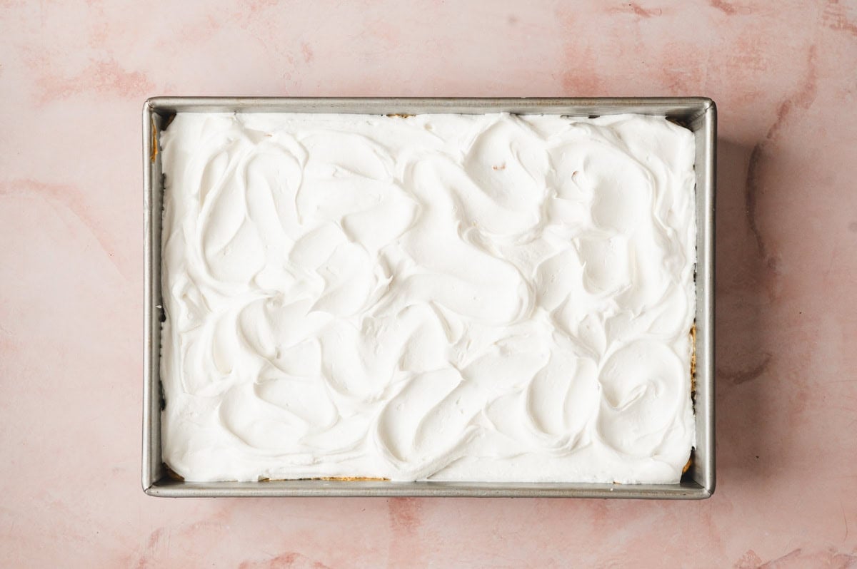 Whipped topping on a layered pumpkin lasagna dessert.