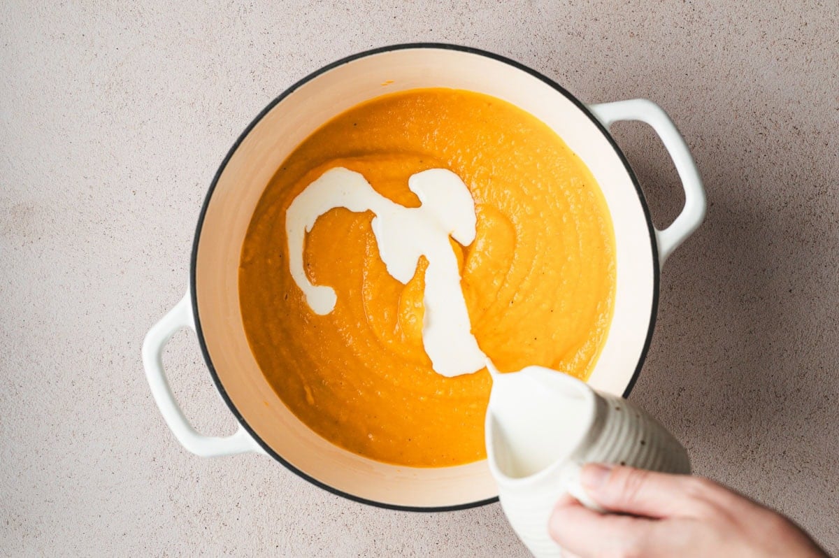 Butternut squash pasta sauce in a pot with cream.