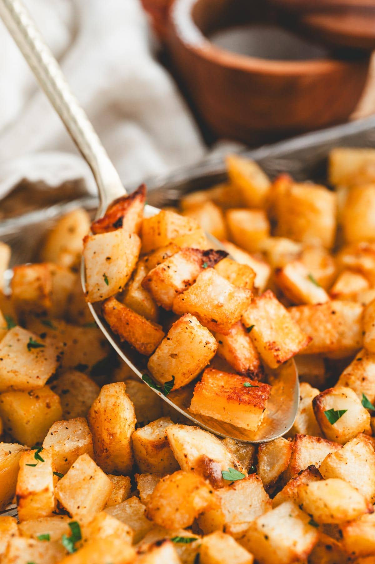 Breakfast potatoes on a serving spoon.