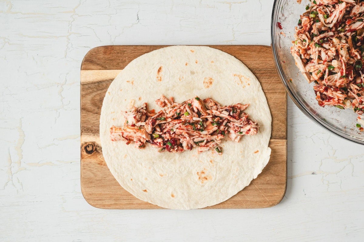 Cranberry turkey enchilada filling on a flour tortilla.