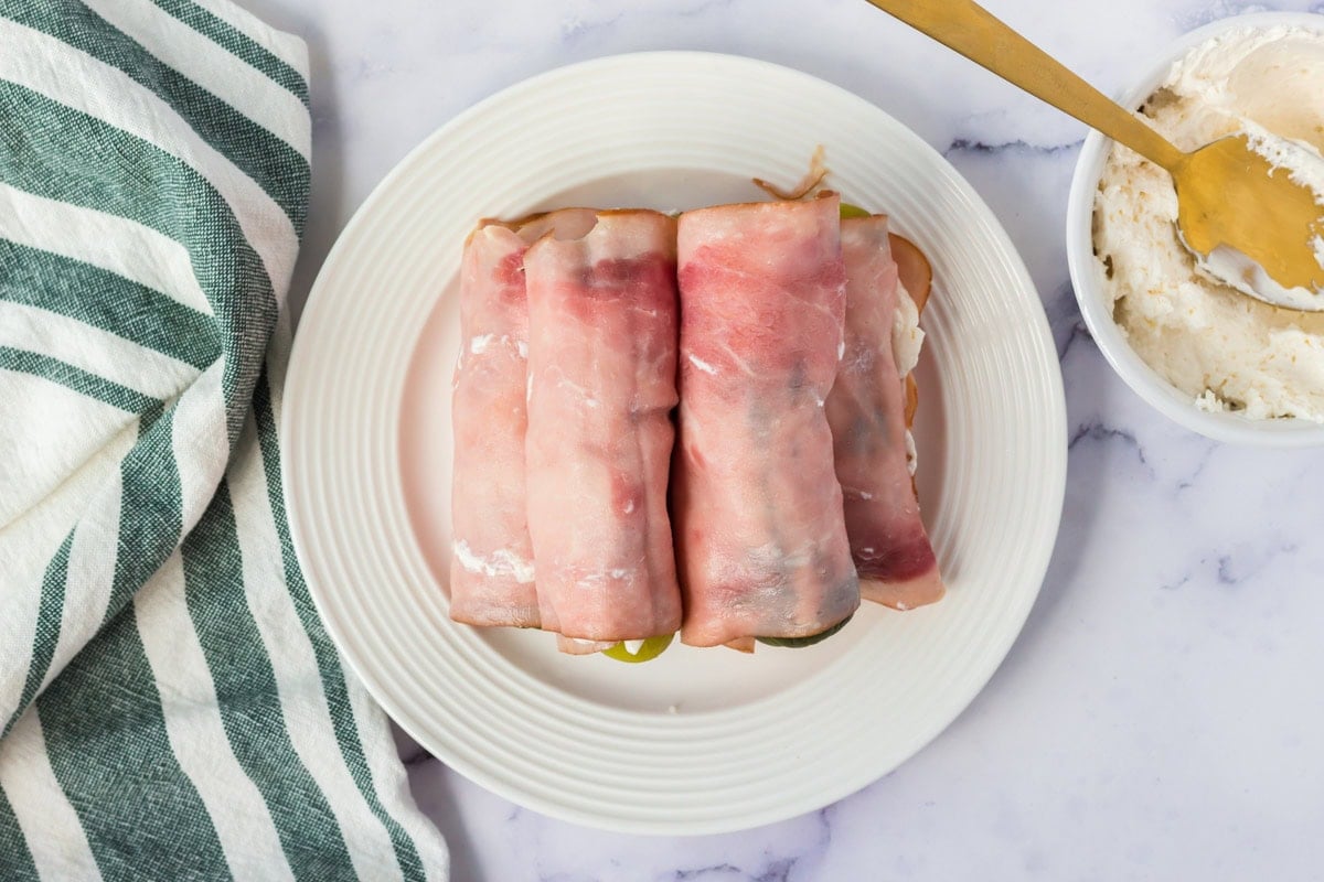 Ham rolled up around pickles with cream cheese.