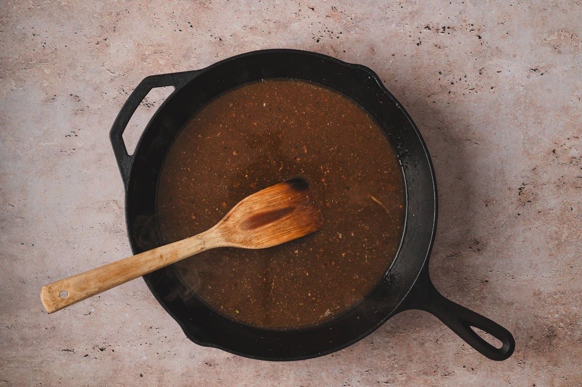 Pan sauce for beef tenderloin in a cast iron pan.
