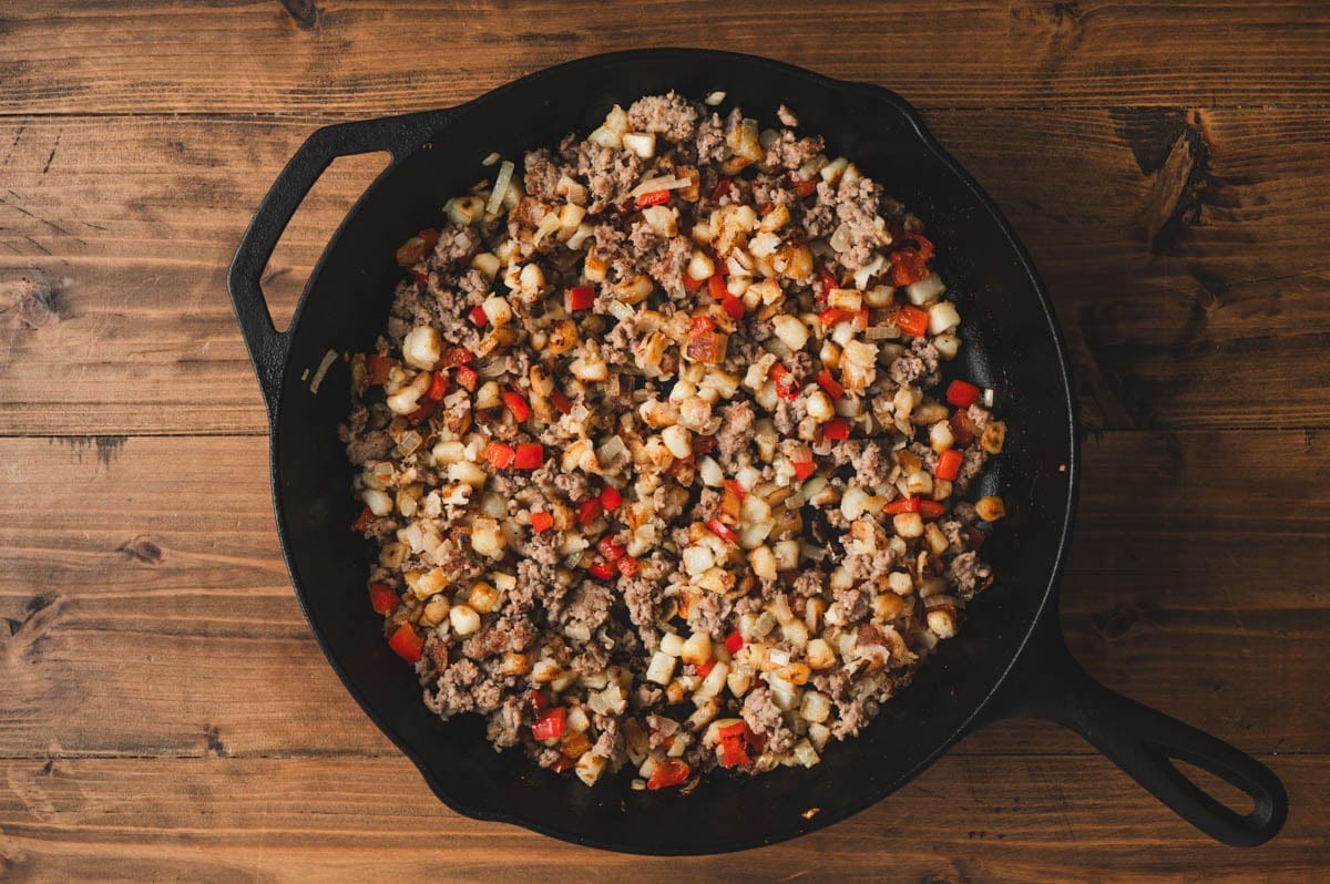 Cooked breakfast has in a cast iron skillet.