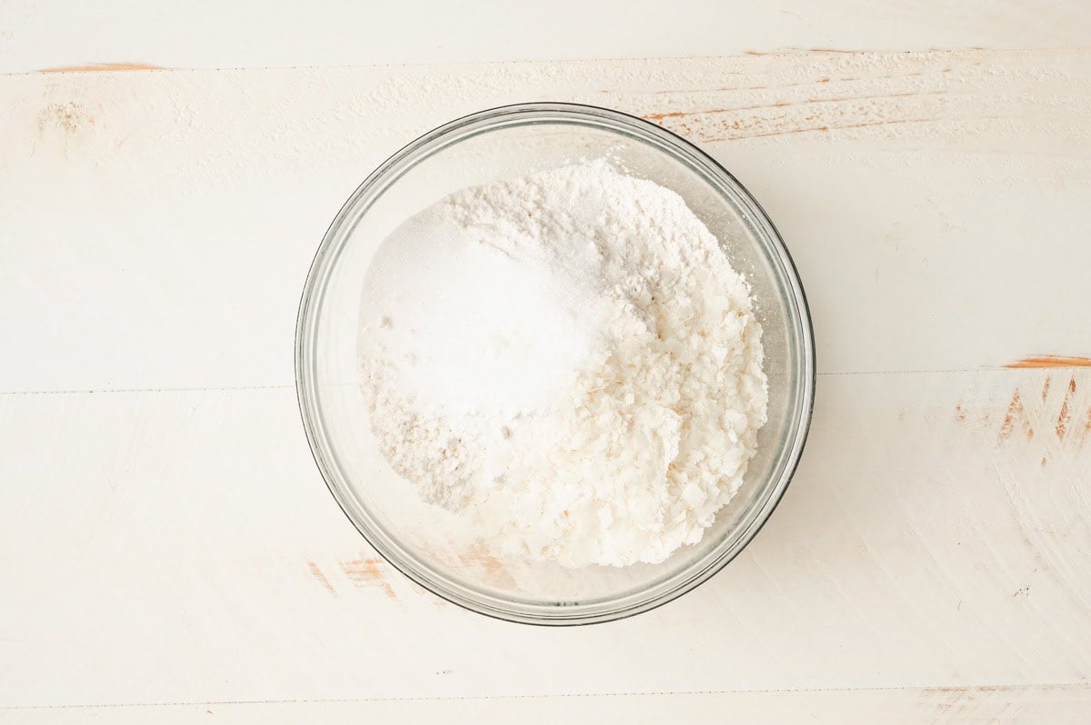 Flour and dry ingredients for the pesto star bread in a glass bowl.