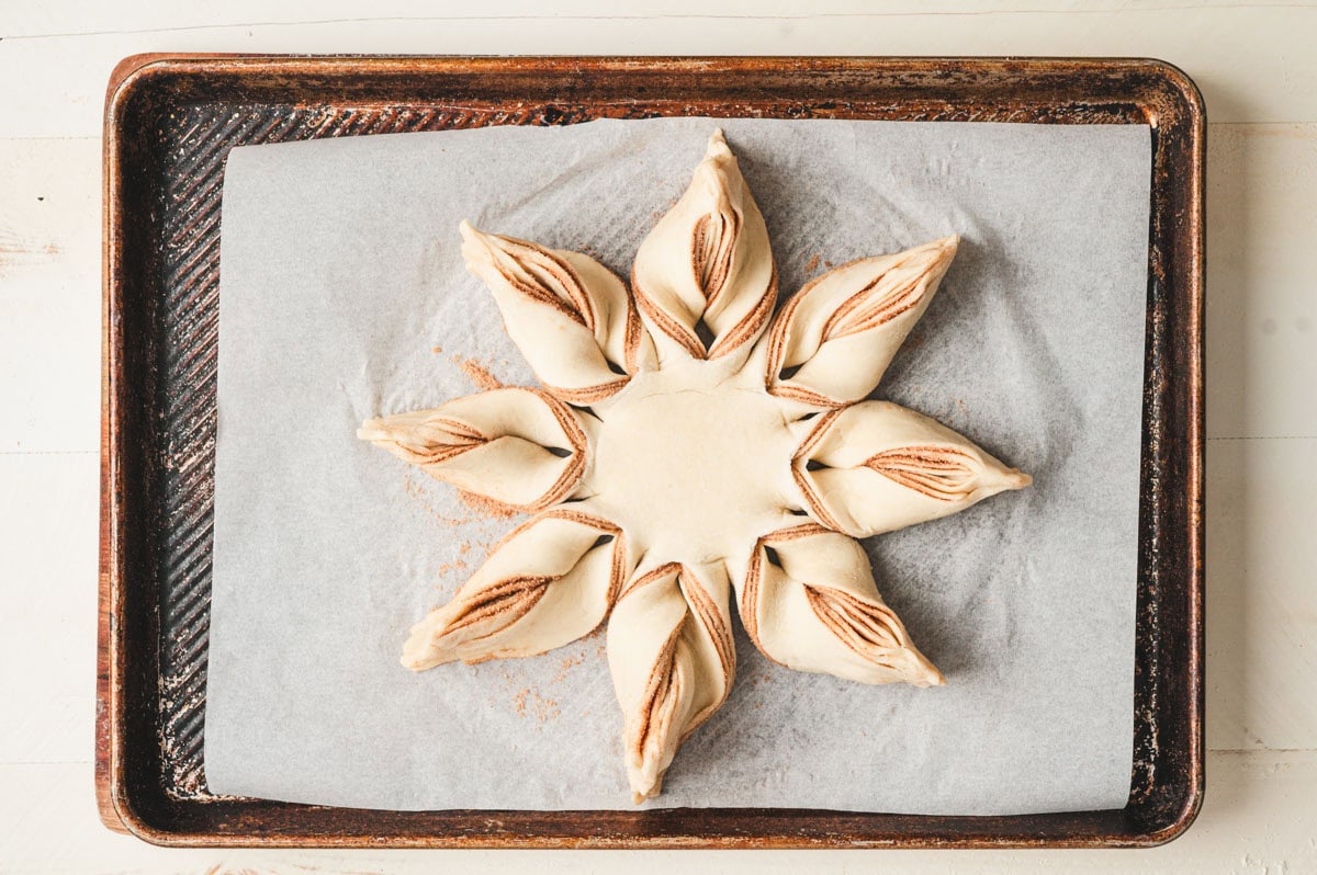 Unbaked cinnamon star bread dough, twisted into shape and ready for baking.