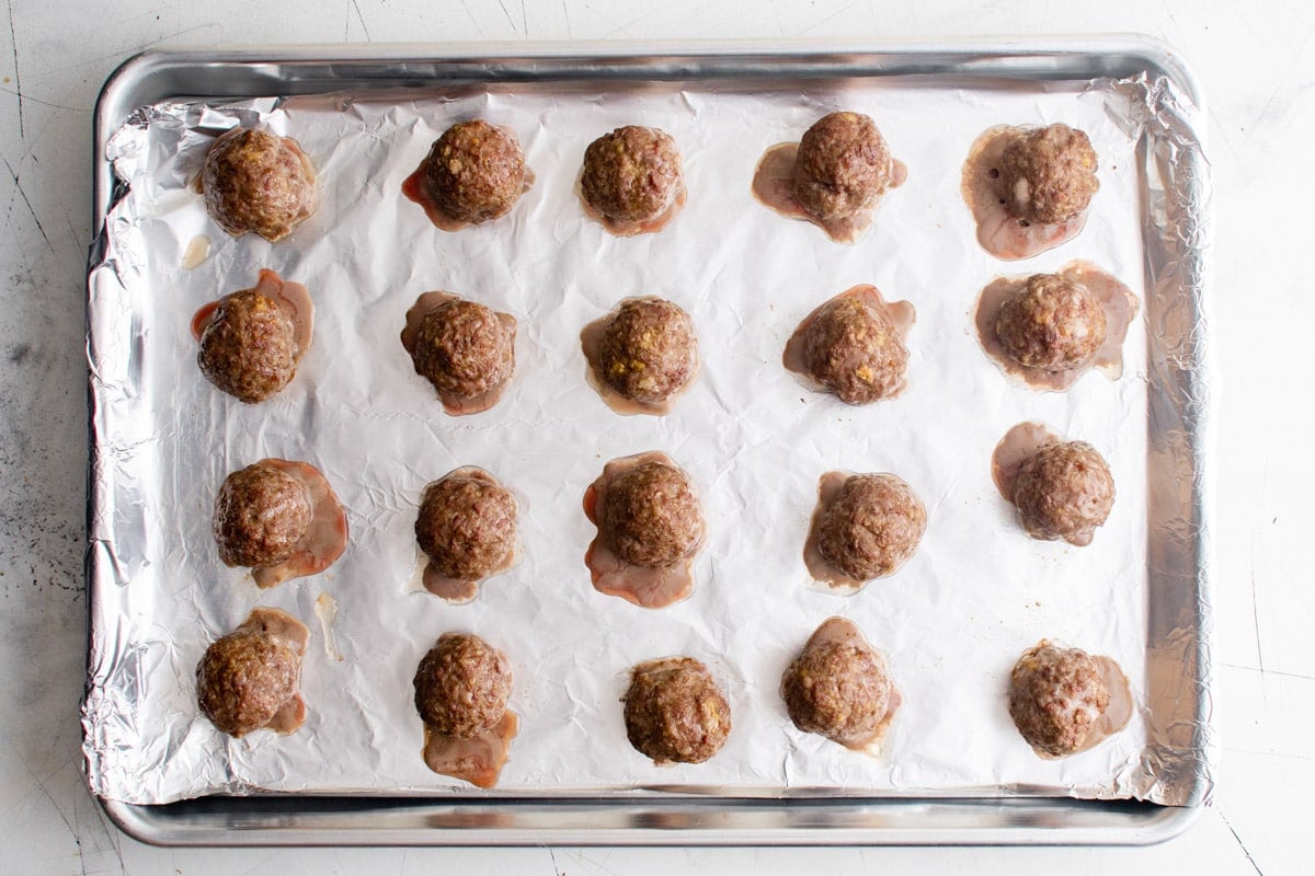 baked meatballs on a foil lined sheet pan