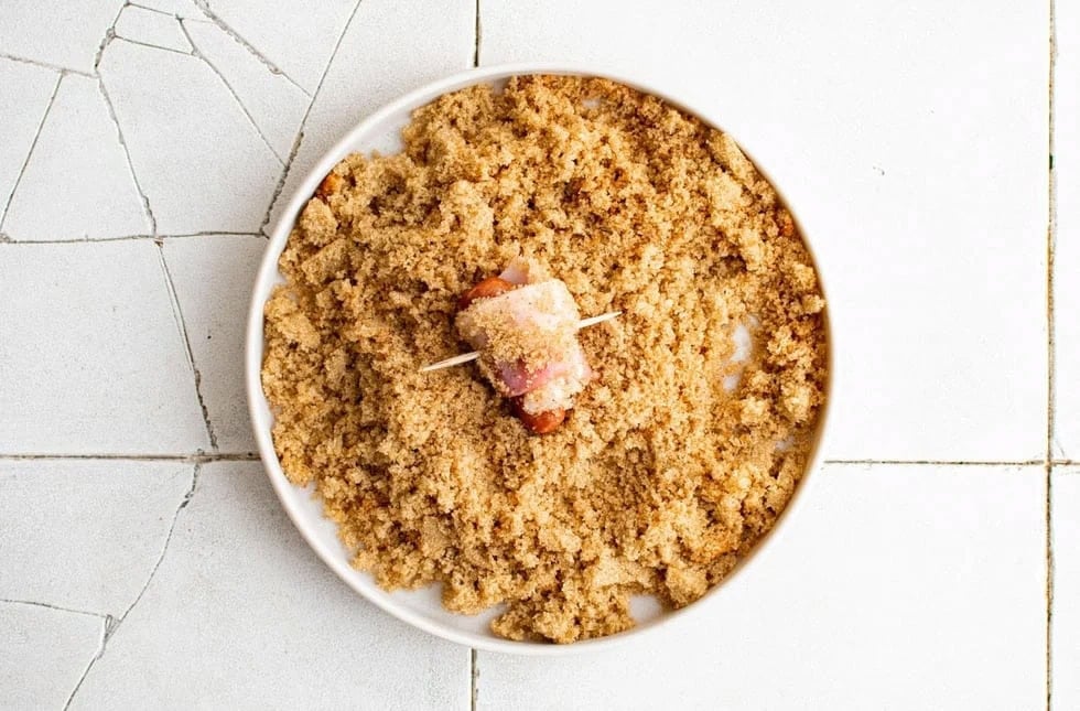 bacon wrapped little smokie rolling in brown sugar and spices